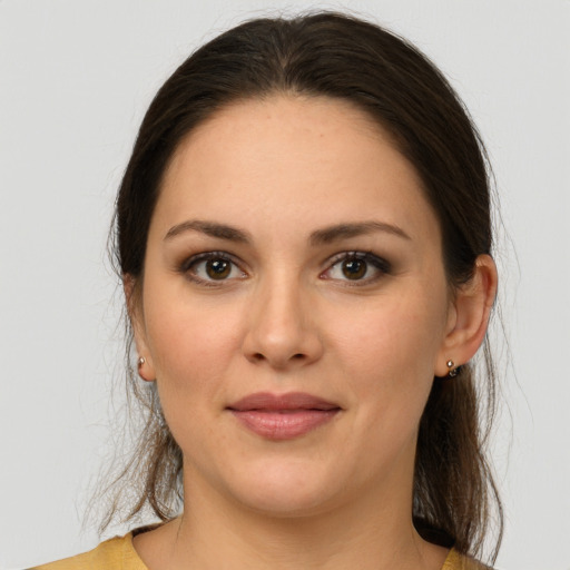 Joyful white young-adult female with long  brown hair and brown eyes