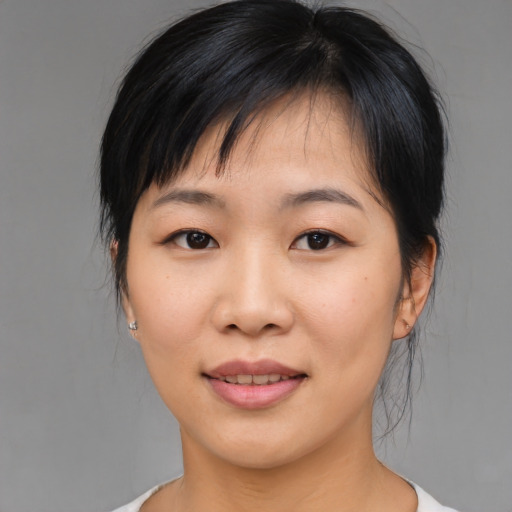 Joyful asian young-adult female with medium  black hair and brown eyes