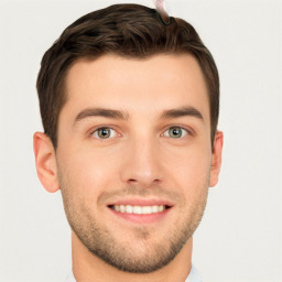 Joyful white young-adult male with short  brown hair and grey eyes