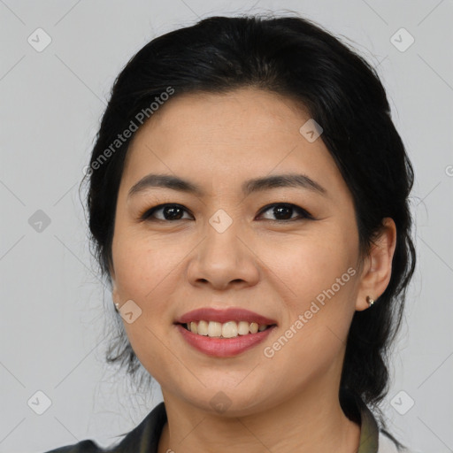 Joyful asian young-adult female with medium  black hair and brown eyes