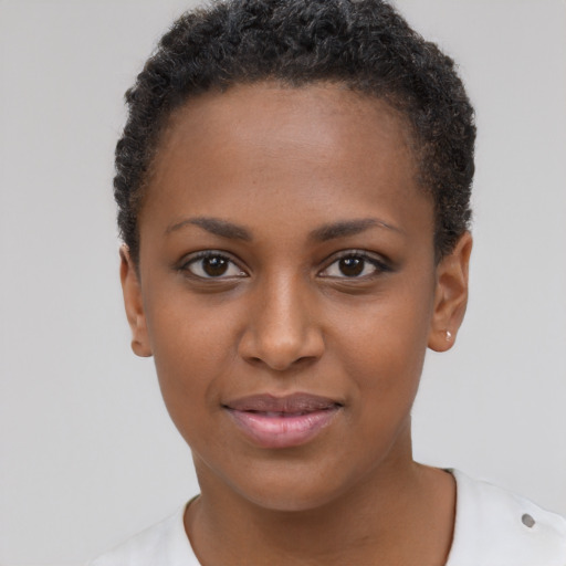 Joyful black young-adult female with short  brown hair and brown eyes