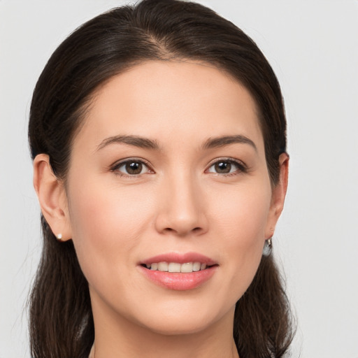 Joyful white young-adult female with long  brown hair and brown eyes