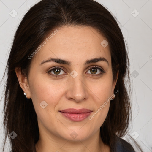 Joyful white adult female with long  brown hair and brown eyes