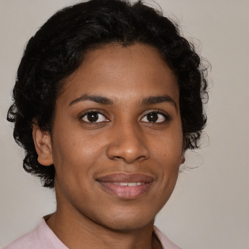 Joyful black young-adult female with medium  brown hair and brown eyes