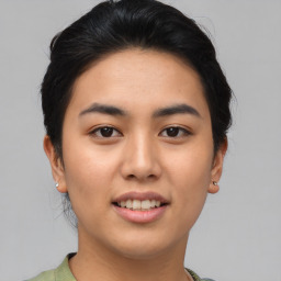 Joyful asian young-adult female with short  brown hair and brown eyes