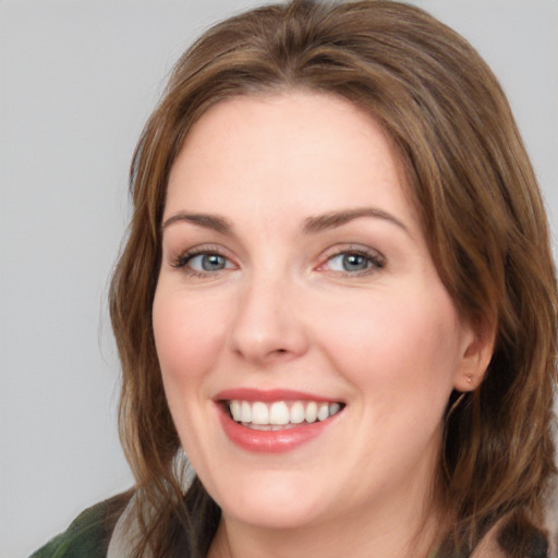 Joyful white young-adult female with medium  brown hair and green eyes