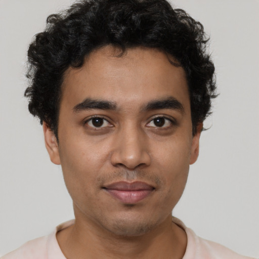 Joyful latino young-adult male with short  brown hair and brown eyes