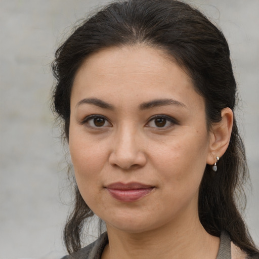 Joyful asian young-adult female with medium  brown hair and brown eyes