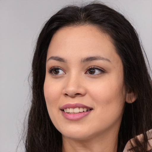 Joyful asian young-adult female with long  brown hair and brown eyes