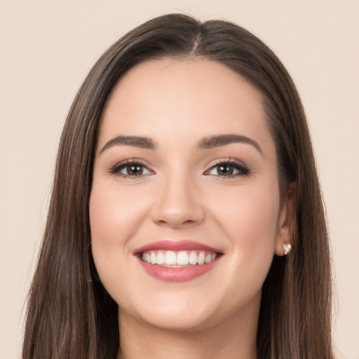 Joyful white young-adult female with long  brown hair and brown eyes