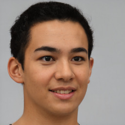 Joyful latino young-adult male with short  brown hair and brown eyes