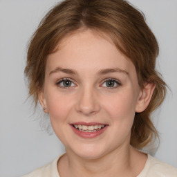 Joyful white young-adult female with medium  brown hair and blue eyes