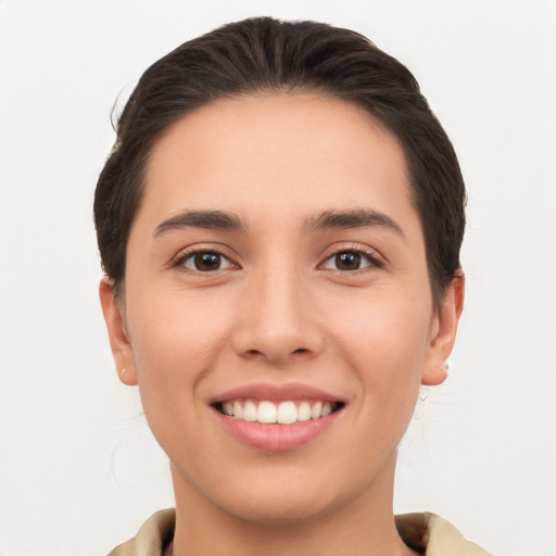 Joyful white young-adult female with short  brown hair and brown eyes