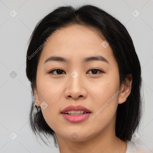 Joyful asian young-adult female with medium  brown hair and brown eyes