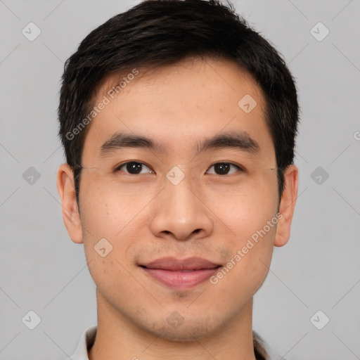 Joyful asian young-adult male with short  brown hair and brown eyes