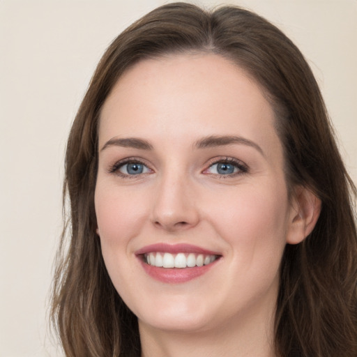 Joyful white young-adult female with long  brown hair and grey eyes