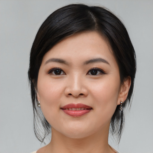 Joyful asian young-adult female with medium  black hair and brown eyes