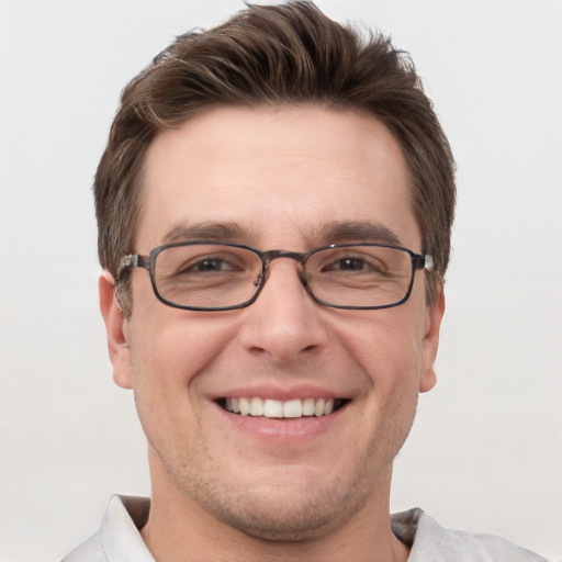 Joyful white adult male with short  brown hair and grey eyes