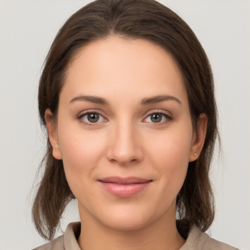 Joyful white young-adult female with medium  brown hair and brown eyes