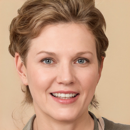 Joyful white young-adult female with short  brown hair and blue eyes