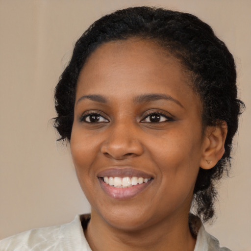 Joyful black young-adult female with medium  black hair and brown eyes
