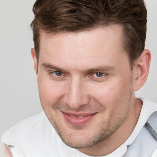 Joyful white adult male with short  brown hair and grey eyes