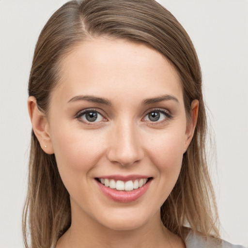 Joyful white young-adult female with long  brown hair and grey eyes