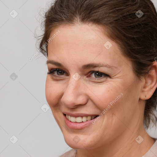 Joyful white adult female with medium  brown hair and brown eyes