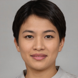 Joyful asian young-adult female with short  brown hair and brown eyes