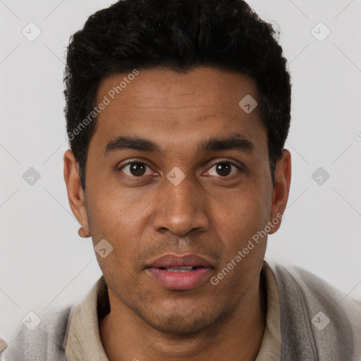 Joyful latino young-adult male with short  brown hair and brown eyes