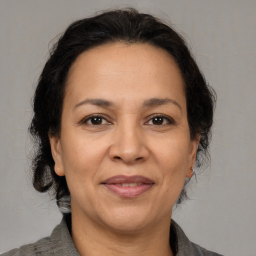 Joyful white adult female with medium  brown hair and brown eyes