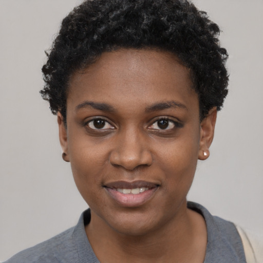 Joyful black young-adult female with short  black hair and brown eyes