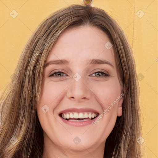 Joyful white young-adult female with long  brown hair and green eyes