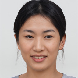 Joyful asian young-adult female with medium  black hair and brown eyes