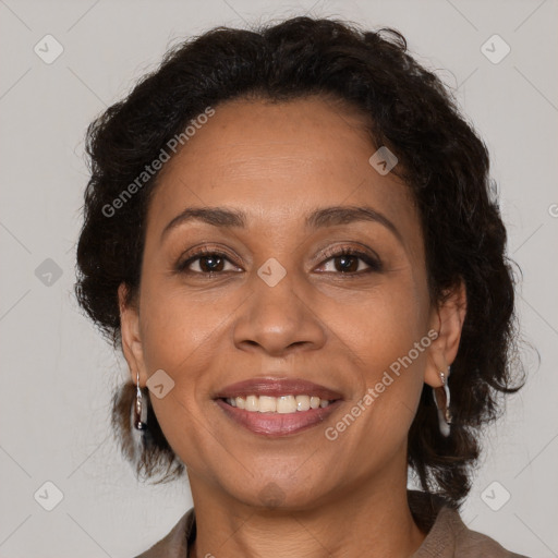 Joyful latino adult female with medium  brown hair and brown eyes