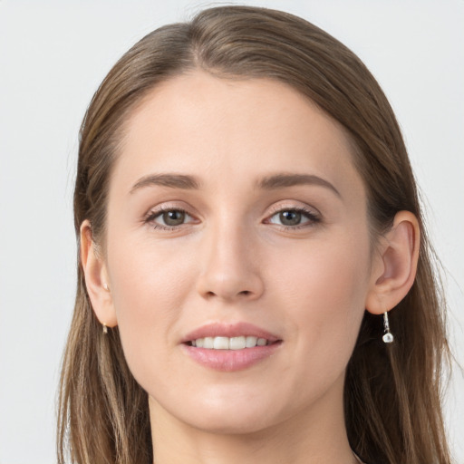 Joyful white young-adult female with long  brown hair and grey eyes