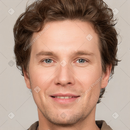 Joyful white adult male with short  brown hair and grey eyes