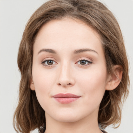 Joyful white young-adult female with medium  brown hair and green eyes