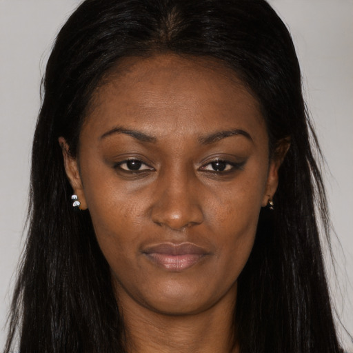 Joyful black young-adult female with long  brown hair and brown eyes