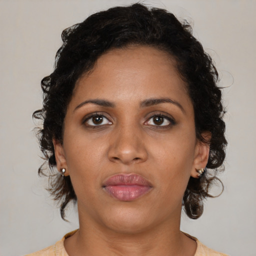 Neutral black young-adult female with medium  brown hair and brown eyes