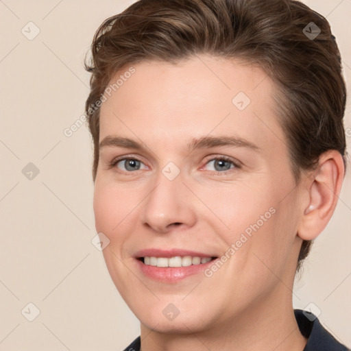 Joyful white young-adult female with short  brown hair and grey eyes