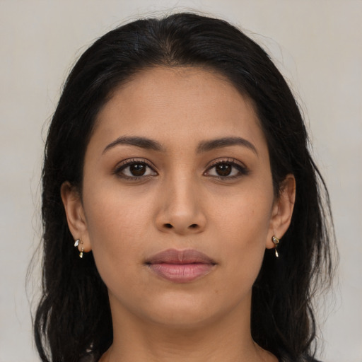 Neutral latino young-adult female with long  brown hair and brown eyes