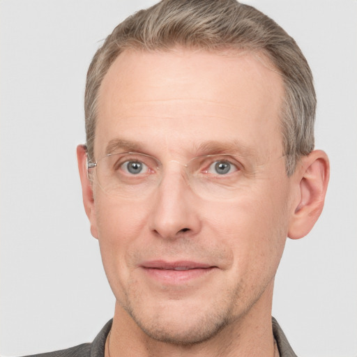 Joyful white adult male with short  brown hair and grey eyes