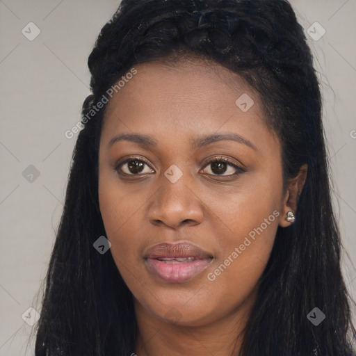 Joyful black young-adult female with long  black hair and brown eyes