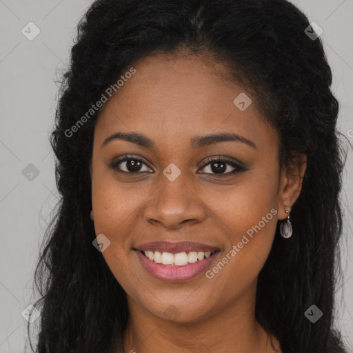 Joyful black young-adult female with long  brown hair and brown eyes