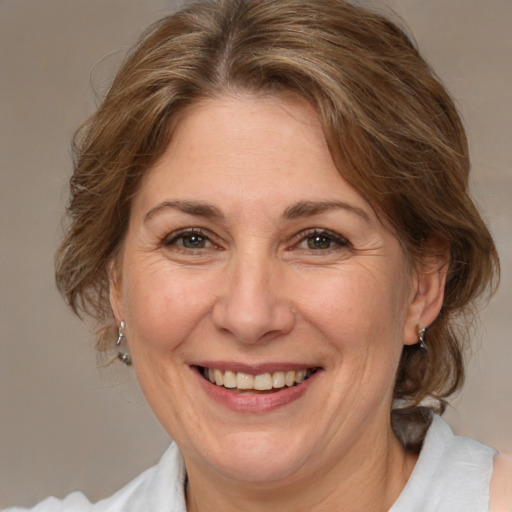 Joyful white adult female with medium  brown hair and brown eyes