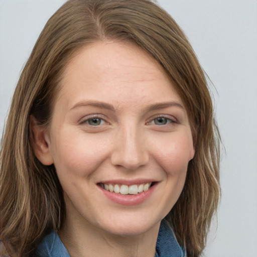 Joyful white young-adult female with medium  brown hair and blue eyes