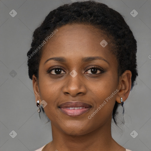 Joyful black young-adult female with short  black hair and brown eyes