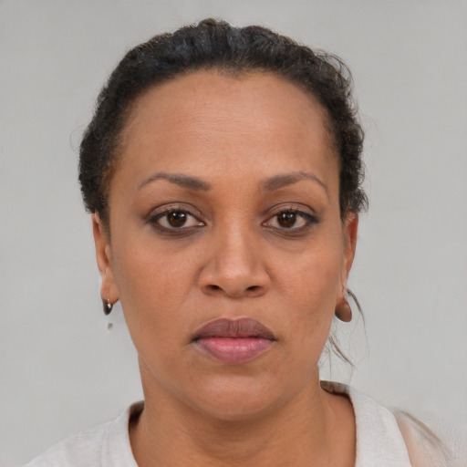 Joyful black adult female with short  brown hair and brown eyes