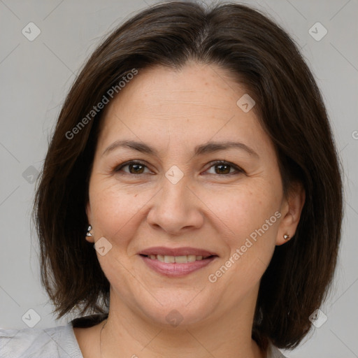 Joyful white adult female with medium  brown hair and brown eyes